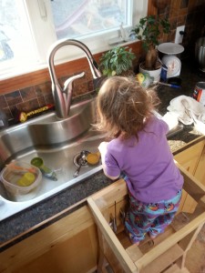 child playing at kitchen sink