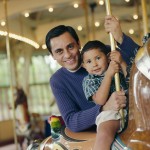 Father and Son Riding Carousel Horse