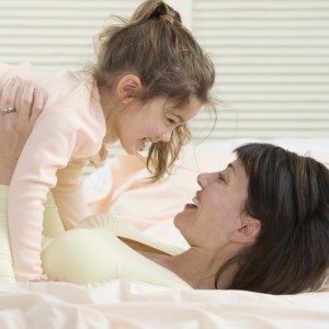 Mother and Daughter Playing on Bed