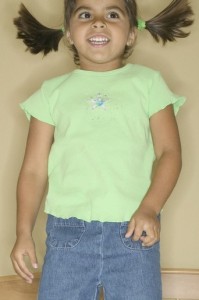 Young girl jumping on a bed